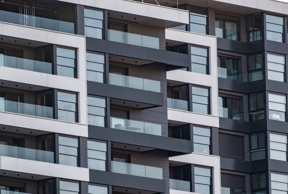 Contemporary apartment facade with glass balconies
