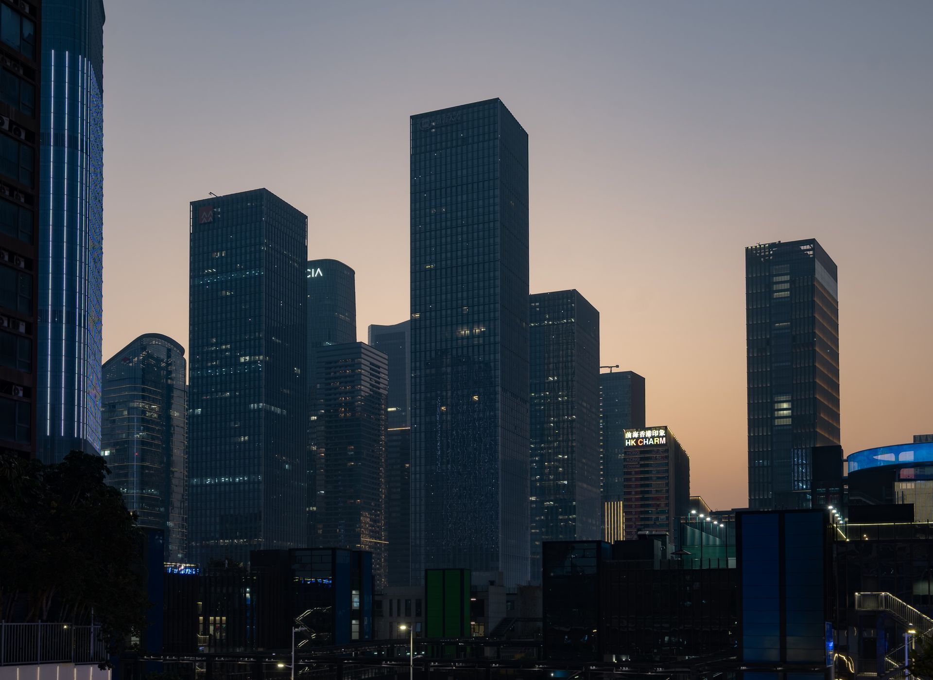 Silhouetted skyscrapers of a modern city against a twilight sky