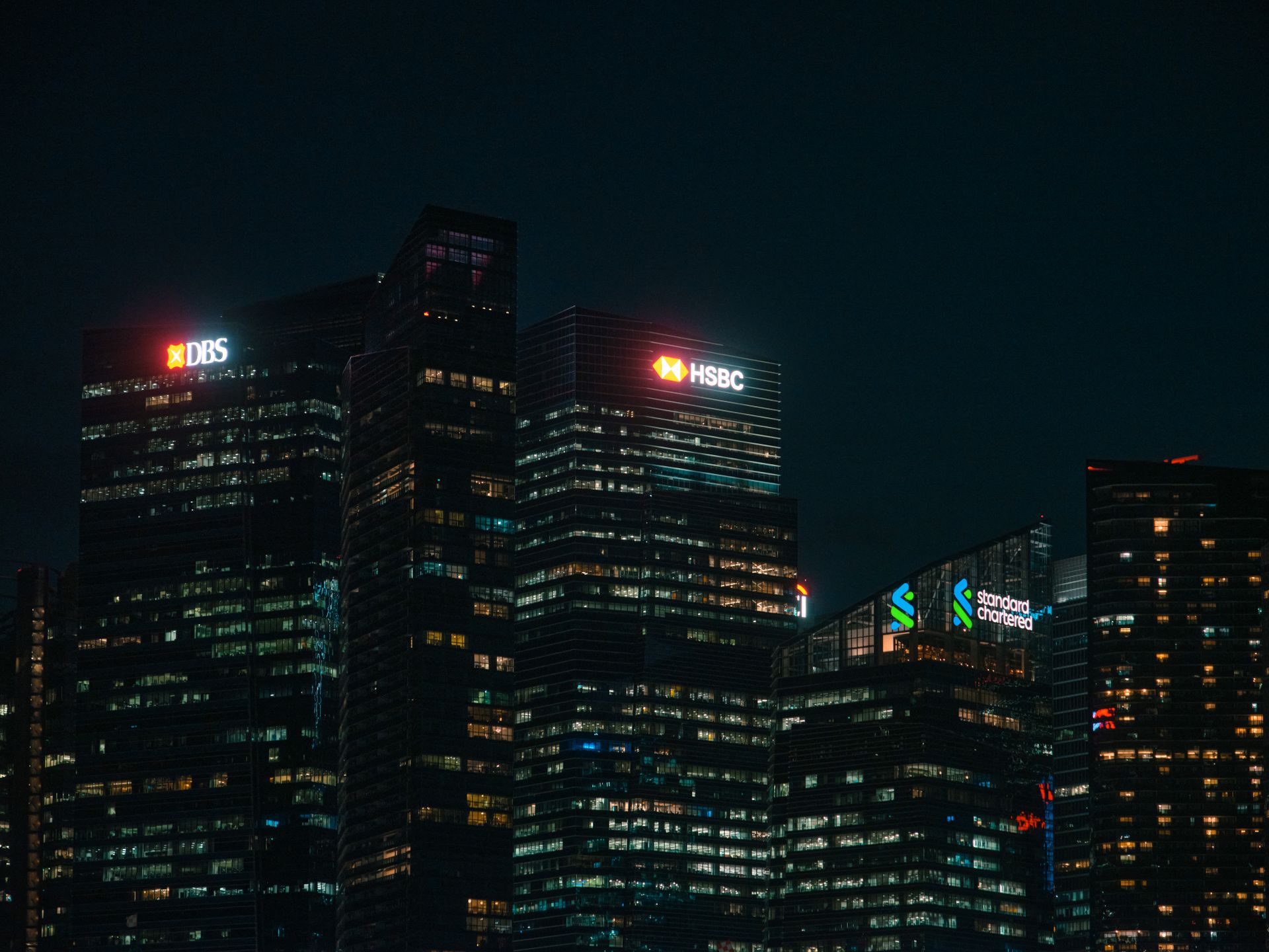 Illuminated city skyscrapers in a financial district at night