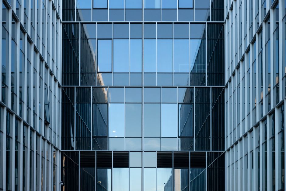 Contemporary building facade with reflective glass windows in an urban environment