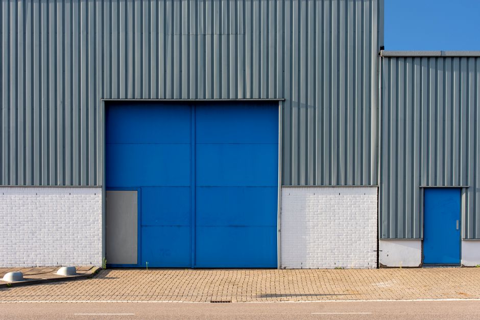 Modern industrial warehouse exterior with large doors