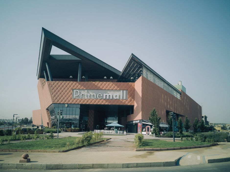 Exterior of a modern shopping mall in an urban setting