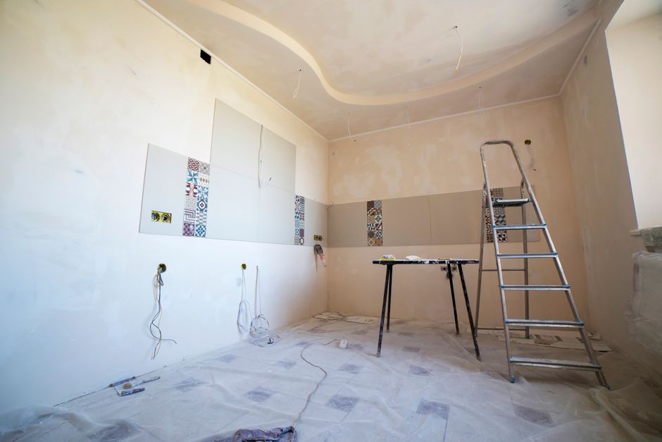 Interior view of a room under renovation with tools and materials
