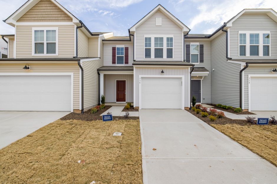 Contemporary suburban homes with garages and neat lawns